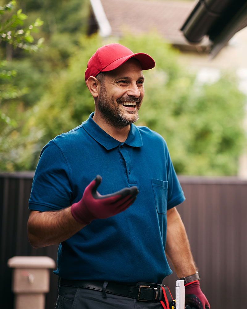 A man in a blue shirt and red hat holds a pest control tool, emphasizing his role in managing pest problems effectively. - TruForce Pest and Wildlife - pest control in knoxville